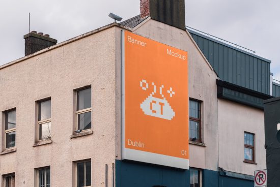 Urban billboard mockup on building exterior with orange background and pixelated graphic design, located in Dublin, ideal for advertising presentations.